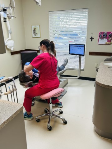 Dental assistant Amy working with a patient at Cooksey Dental