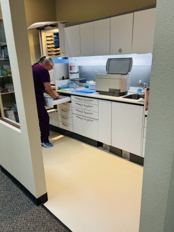 Dental assistant Melinda working in the sterilization lab at Cooksey Dental